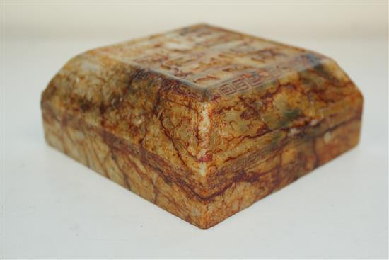 A Chinese archaistic stained and waxed bowenite jade scholars scroll weight, 11cm